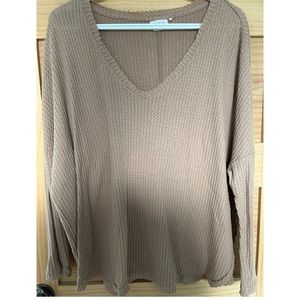 out from under light brown waffle-knit sweater